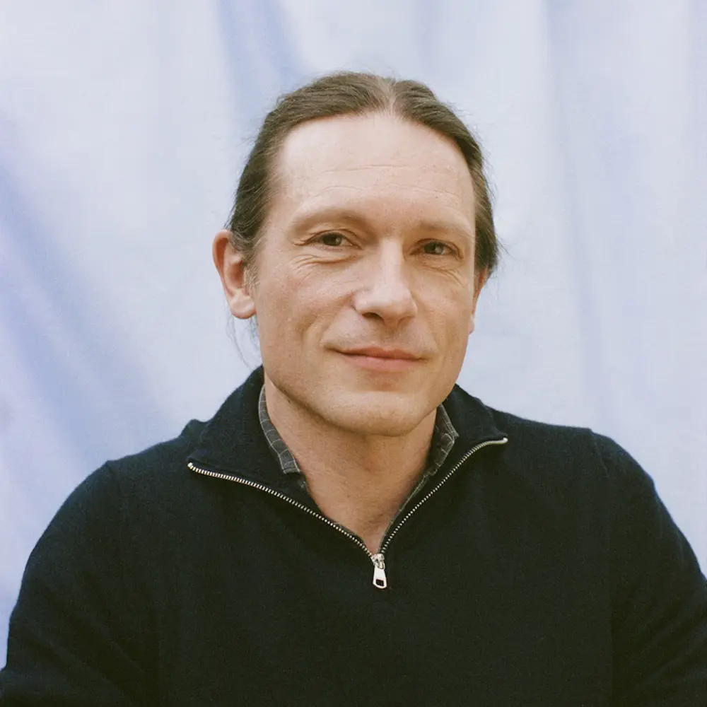 Photo of Yannick Wurm against a blue background