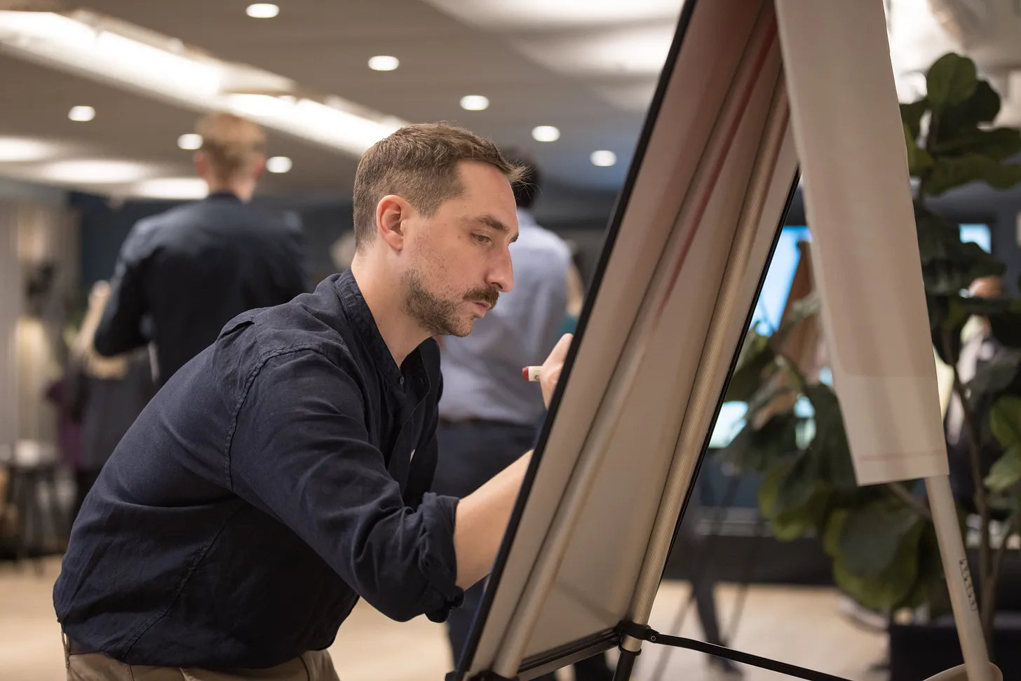 A photo of Jacques writing on a white board.