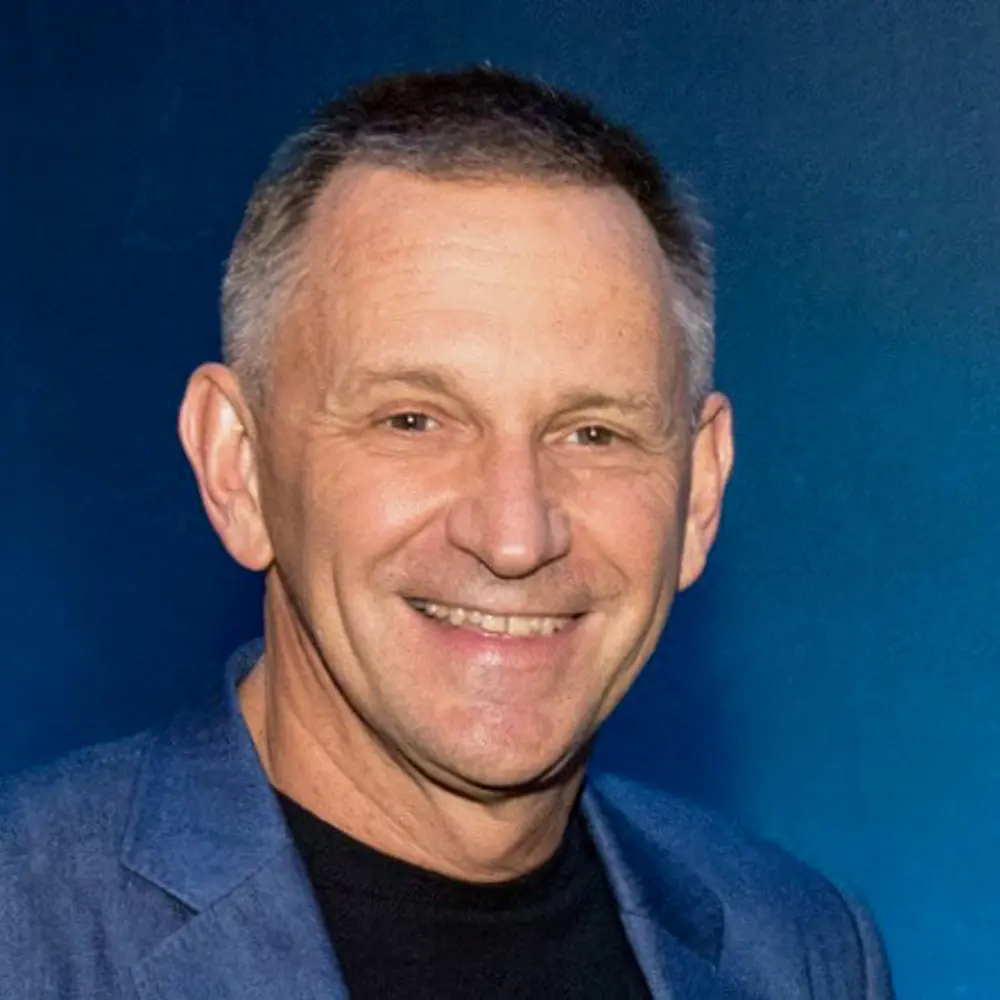 Headshot of Nick McKeown against a blue background